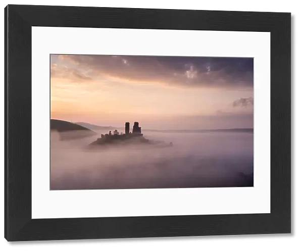 Corfe castle and village at dawn with mist, Corfe Castle, The Purbecks, Dorset, UK