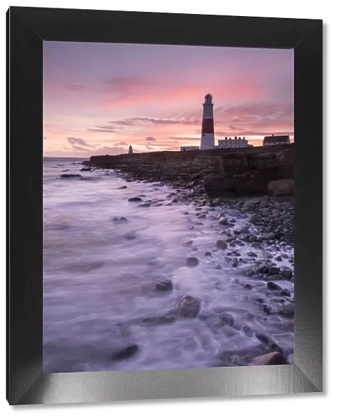 Coastline and Portland Bill Lighthouse at sunset. Isle of Portland, Dorset, England, UK. January 2016