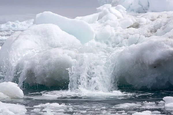 Meltwater flowing off an iceberg. Near Yalour Islands, Wilhelm Archipelago, Antarctica