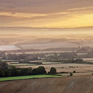 Dawn mist and rolling chalk downland viewed from Wilmington Hill, Wilmington, South
