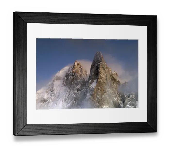 Framed Print : Mountains in snow, Aiguille du Dru with snow blowing off from the top at night. Chamonix