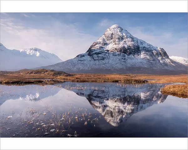 Buachaille Etive Beag reflected in Lochan na Fola after snowfall, early morning light, Glencoe, Scotland, UK. March 2017