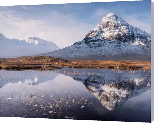 Buachaille Etive Beag reflected in Lochan na Fola after snowfall, early morning light, Glencoe, Scotland, UK. March 2017