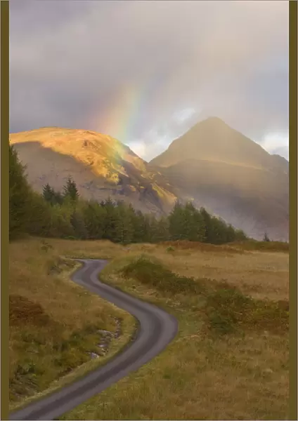 Mountain road with rainbow in Glen Etive, Argyll, Scotland, UK, October 2007