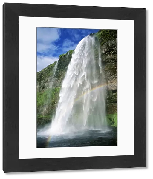 Rainbow in spray of Seljalandsfoss waterfall, Iceland
