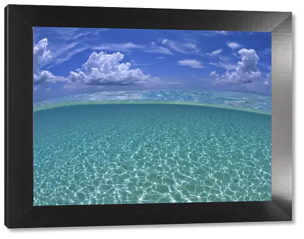 A split level view of shallow water and clouds in summer, Seven Mile Beach, Grand Cayman