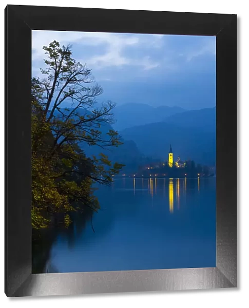 Assumption of Mary Pilgrimage Church, in twilight, reflected in Lake Bled, Bled, Slovenia