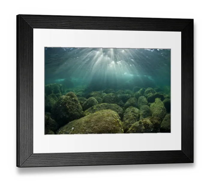 Framed Print : Afternoon sunrays dancing over rocks, in shallow water. Capo Comino, Sardinia, Italy Framed Print : Afternoon sunrays dancing over rocks, in shallow water. Capo Comino, Sardinia, Italy