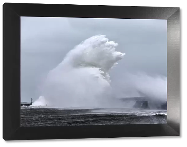 Massive wave crashing into Lesconil during Storm Petra, Finistere, Brittany, France