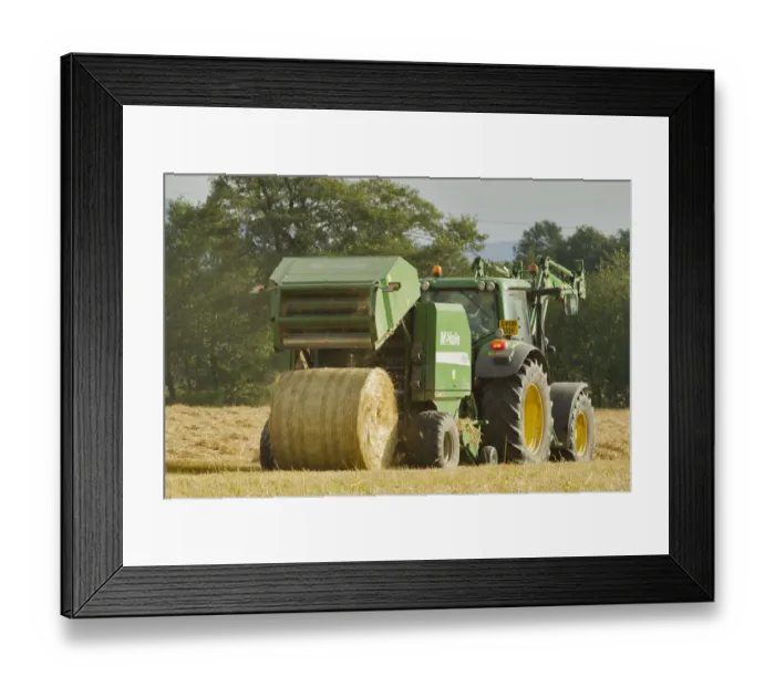 Framed Print : Baling machine ejecting a bale of Barley straw on arable farmland, Scotland, UK Framed Print : Baling machine ejecting a bale of Barley straw on arable farmland, Scotland, UK