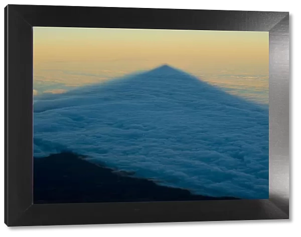 Shadow of the Teide volcano in sea of clouds at sunset, Teide National Park, Tenerife