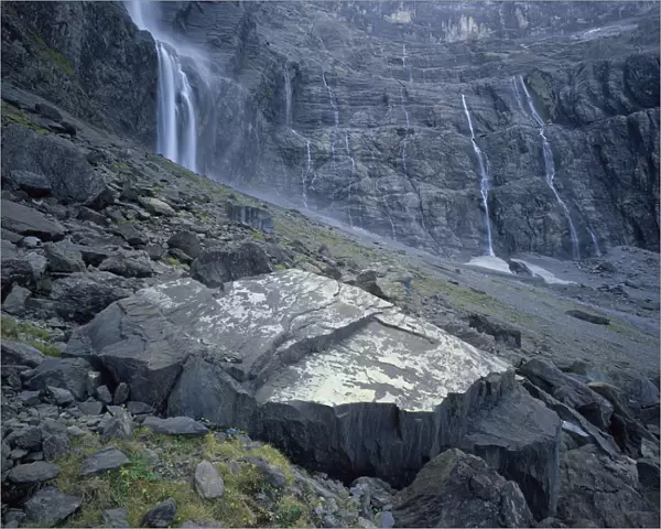 Waterfalls flowing down rock faces in the Cirque de Gavarnie, Pyrenees, France, October