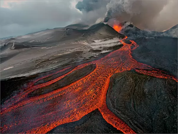 Tolbachik Volcano erupting with lava flowing down the mountain side. Kamchatka, Russia