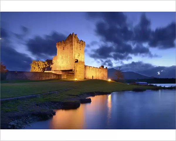 Ross Castle lit up at twilight, Killarney National Park, County Kerry, Republic of Ireland