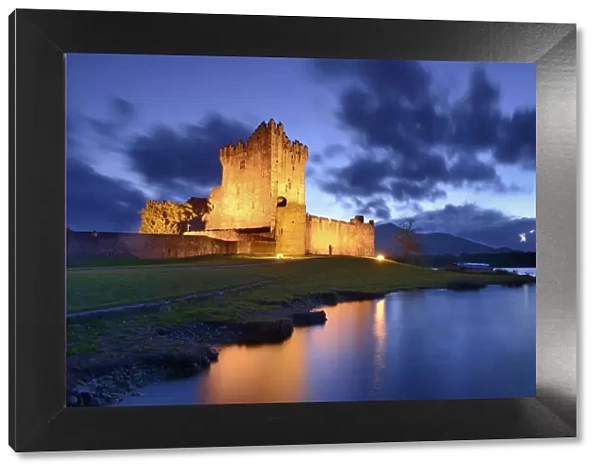 Ross Castle lit up at twilight, Killarney National Park, County Kerry, Republic of Ireland