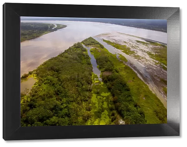 Aerial view of Amazon River, with settlements and secondary rainforest, near Iquitos, Peru