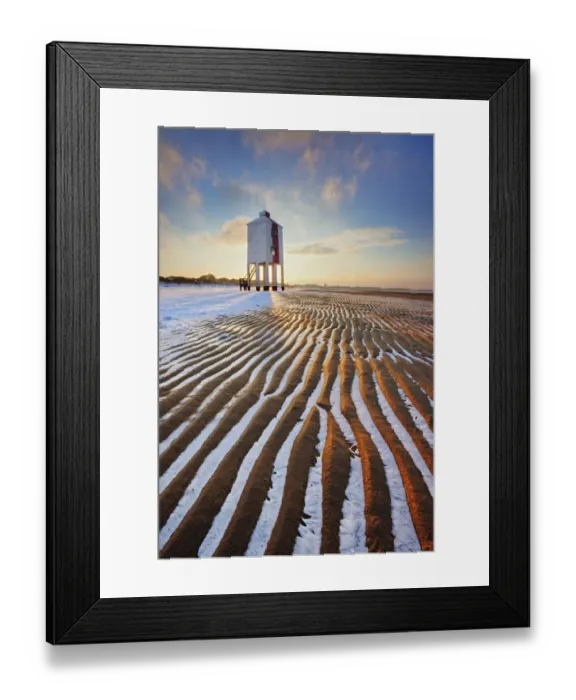 Framed Print : Sand patterns with ice between ripples of the sand, front of Burnham-on-Sea Lighthouse in winter