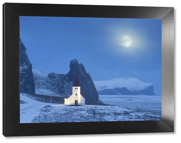 Vik i Myrdal church in winter, with full moon, Iceland. January 2015