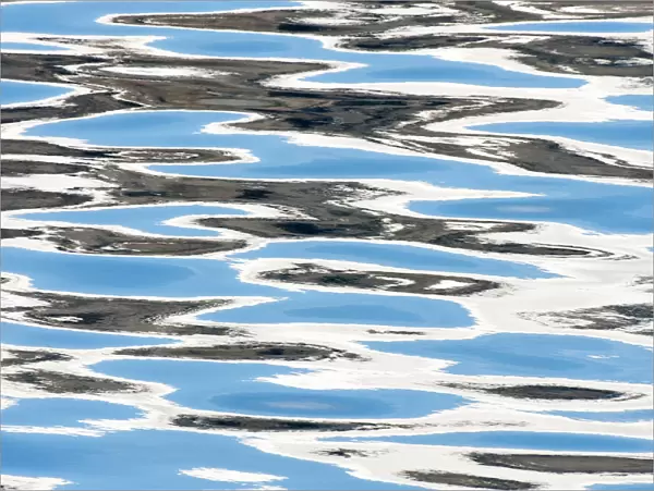 Reflections of clouds in ripples of sea water, Svalbard, Norway, June 2010