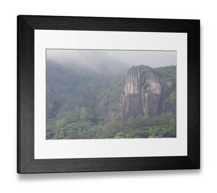 Framed Print : Pristine tropical rainforest and granite cliffs in mist, Morne Seychelles National Park