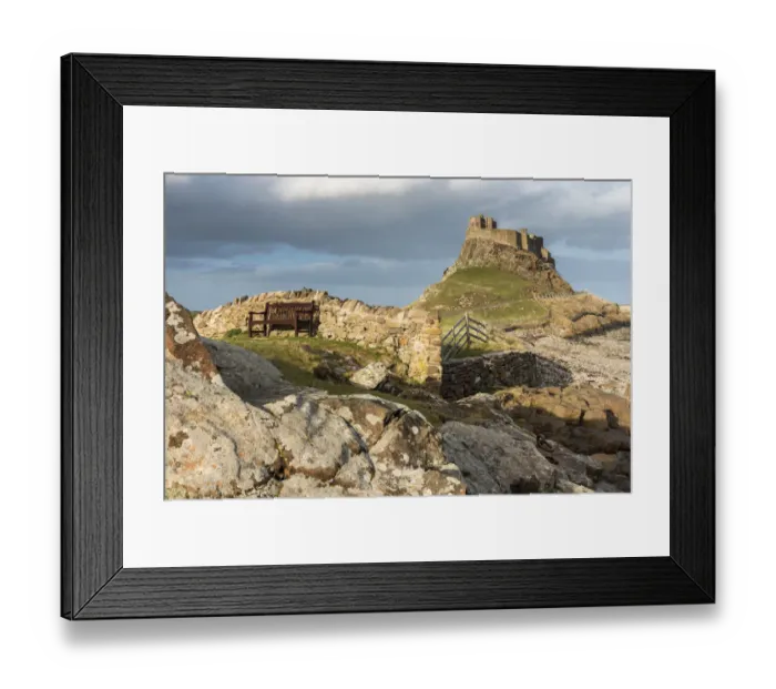 Framed Print : Bench in front of a wall with Lindisfarne Castle in the distance, Holy Island, Northumberland Framed Print : Bench in front of a wall with Lindisfarne Castle in the distance, Holy Island, Northumberland