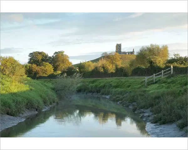 Landscape with river Parrett in foreground and Burrow Mump in background, with ruined church