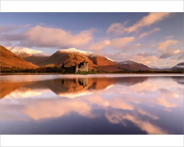 Kilchurn Castle, sunrise, early morning sunlight, a ruin on a rocky peninsula, the northeastern end of Loch Awe, in Argyll and Bute, Scotland, UK. October