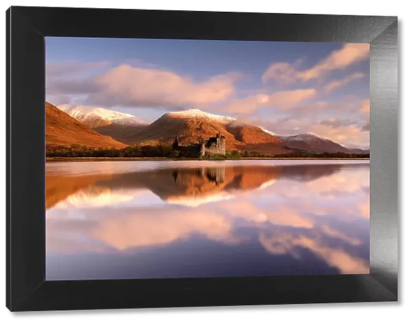 Kilchurn Castle, sunrise, early morning sunlight, a ruin on a rocky peninsula, the northeastern end of Loch Awe, in Argyll and Bute, Scotland, UK. October