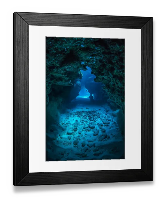 Framed Print : View through a cavern in a coral reef, with a Small grouper (Cephalopholis cruentata Framed Print : View through a cavern in a coral reef, with a Small grouper (Cephalopholis cruentata