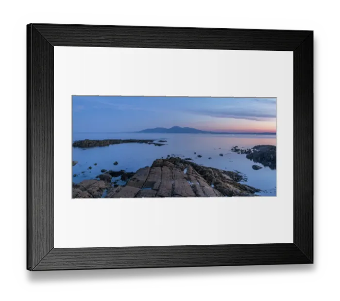 Framed Print : Rocky shore on St Johns Point at sunset, mountains in distance across sea Framed Print : Rocky shore on St Johns Point at sunset, mountains in distance across sea