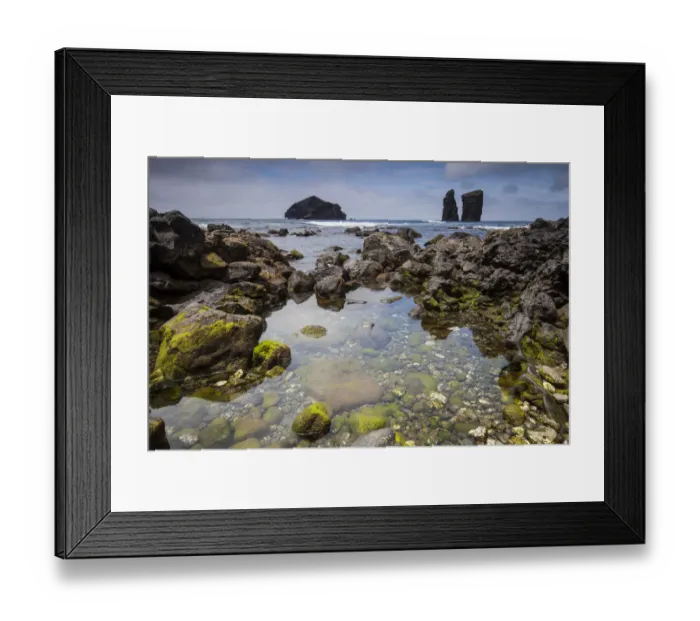 Framed Print : Rock pool in volcanic rock. Sea stacks and island in background Framed Print : Rock pool in volcanic rock. Sea stacks and island in background
