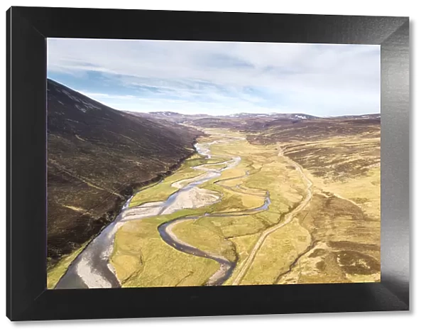 Aerial view of the upper River Dulnain running through open moorland, Monadhliath mountains, Highlands, Scotland, UK. May, 2020