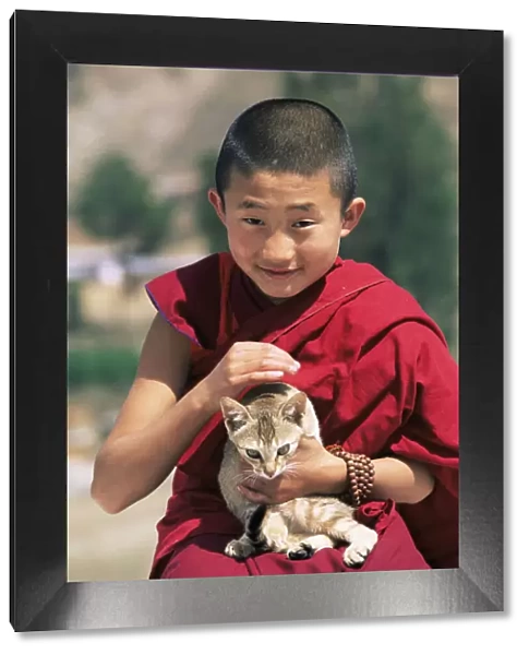 Young buddhist monk holding cat, Punakha Dzong, Central Bhutan 2001