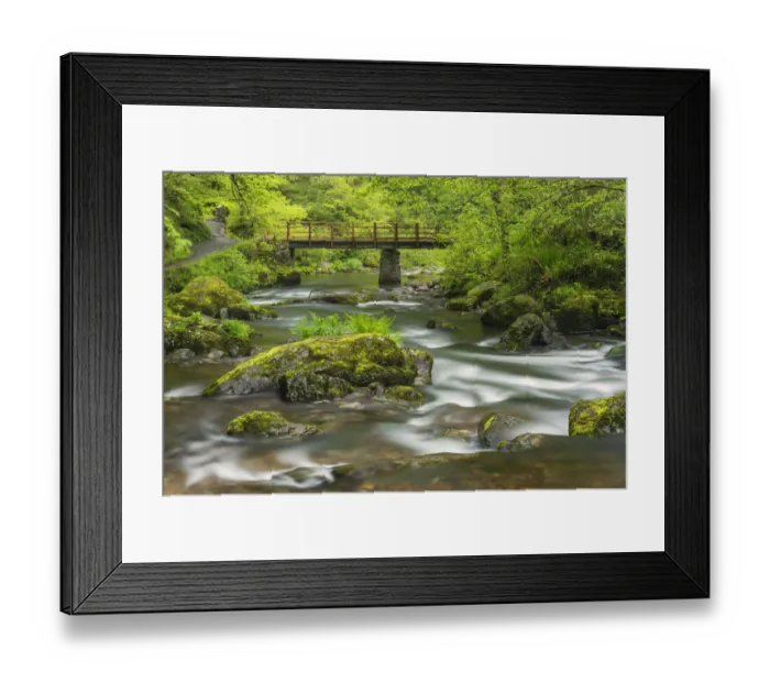 Framed Print : Mossy boulders and wooden bridge over East Lyn River. Exmoor National Park, Devon, UK. May Framed Print : Mossy boulders and wooden bridge over East Lyn River. Exmoor National Park, Devon, UK. May
