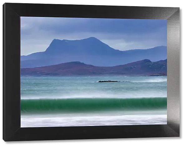 Waves breaking on the beach at Mellon Udrigle, with Beinn Ghobhlach mountain in background, Wester Ross, Scotland, UK. January, 2022