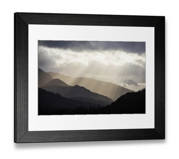 Framed Print : Sun rays shining through clouds onto Loughrigg Fell and hills of the Lake District National Park, in evening. Ambleside, Cumbria, England, UK. April 2020 Framed Print : Sun rays shining through clouds onto Loughrigg Fell and hills of the Lake District National Park, in evening. Ambleside, Cumbria, England, UK. April 2020