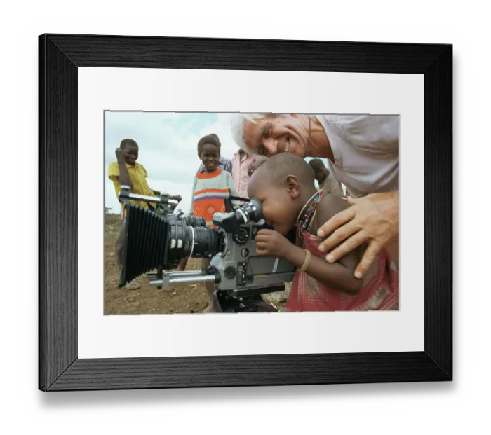 Framed Print : Masai child looking through film camera lens with cameraman Alan Hayward, on location for BBC series Lifesense, Kenya, East Africa 1991 Framed Print : Masai child looking through film camera lens with cameraman Alan Hayward, on location for BBC series Lifesense, Kenya, East Africa 1991