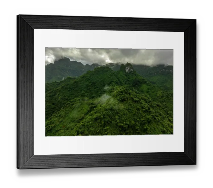 Framed Print : Aerial view of a dense vegetation covering mountain peaks surrounded by early morning clouds and fog, Namosi Province, Viti Levu, Fiji. June, 2023