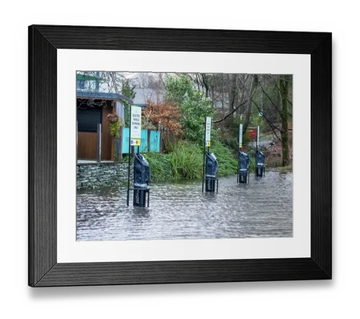 Framed Print : Electric car charging points submerged in water in a flooded carpark after heavy rain, Ambleside, Lake District, Cumbria, UK. January, 2023