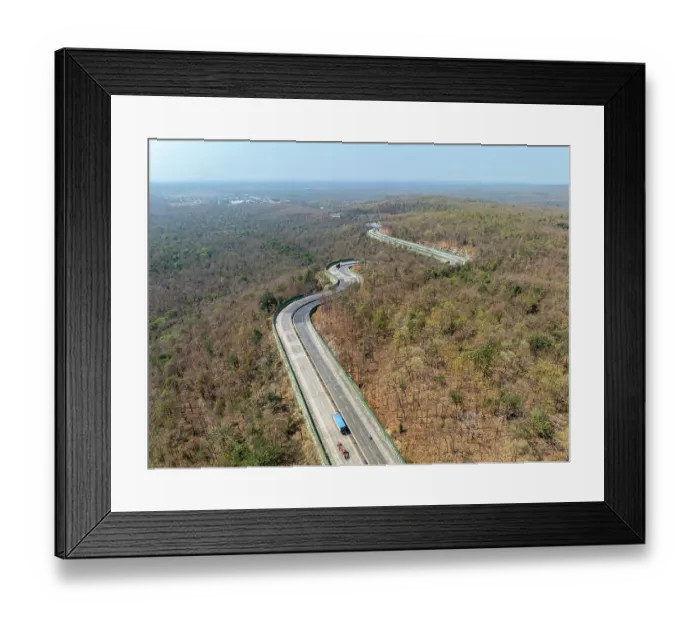 Framed Print : Drone shot of National Highway NH-44, the longest national highway in India, seen here passing through Pench Tiger Reserve, Madhya Pradesh, India Framed Print : Drone shot of National Highway NH-44, the longest national highway in India, seen here passing through Pench Tiger Reserve, Madhya Pradesh, India