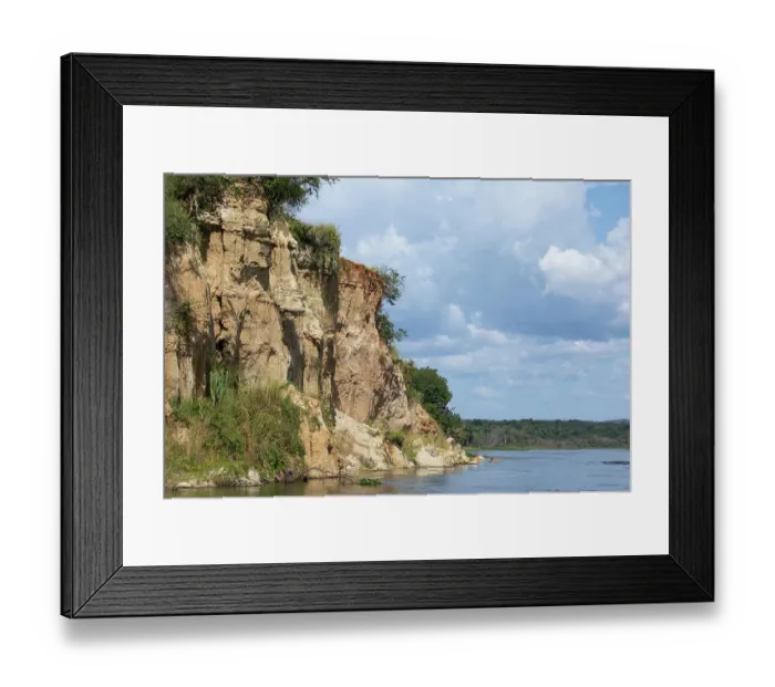 Framed Print : View of steep cliffs along riverbank and Nile River, Murchison Falls National Park, Uganda. November, 2022 Framed Print : View of steep cliffs along riverbank and Nile River, Murchison Falls National Park, Uganda. November, 2022