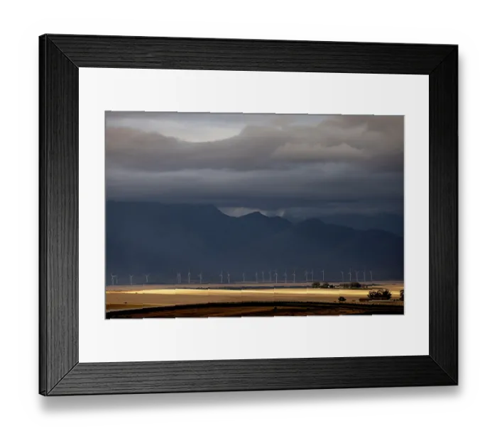 Framed Print : Wind turbines under a stormy sky on a farm near the town of Hermon, outside Cape Town, Western Cape, South Africa. February, 2024 Framed Print : Wind turbines under a stormy sky on a farm near the town of Hermon, outside Cape Town, Western Cape, South Africa. February, 2024