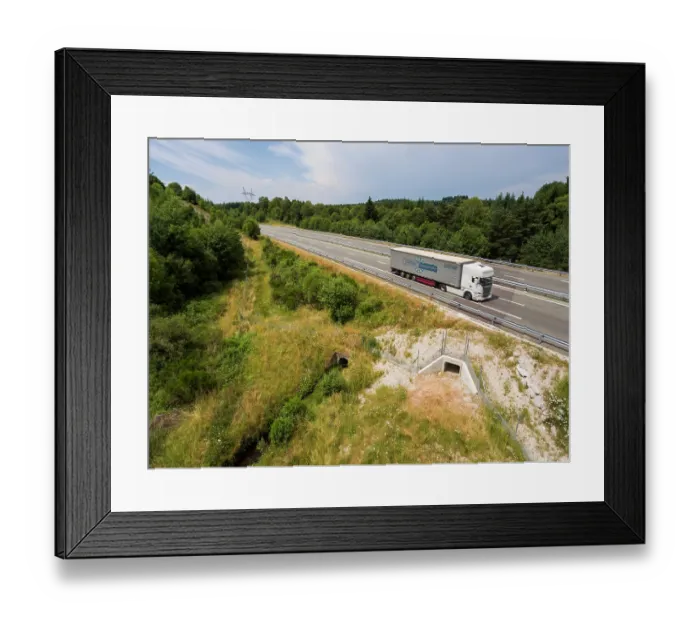 Framed Print : Aerial view of a wildlife underpass below the A89 highway with truck driving by above, Correze, France. July, 2018 Framed Print : Aerial view of a wildlife underpass below the A89 highway with truck driving by above, Correze, France. July, 2018