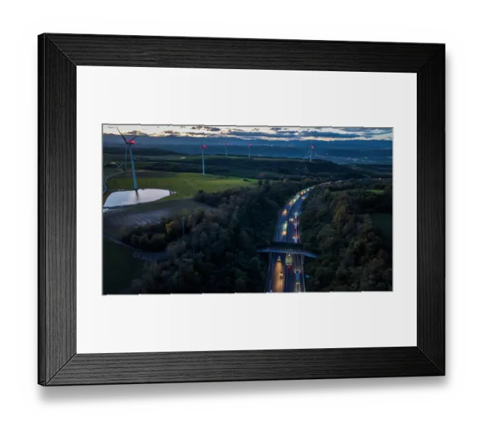 Framed Print : Aerial view of a wildlife crossing over the A7 highway at dusk, built in 2011, with wind turbines along the highway and city of Salaise-sur-Sanne in the distance, Drome, France Framed Print : Aerial view of a wildlife crossing over the A7 highway at dusk, built in 2011, with wind turbines along the highway and city of Salaise-sur-Sanne in the distance, Drome, France