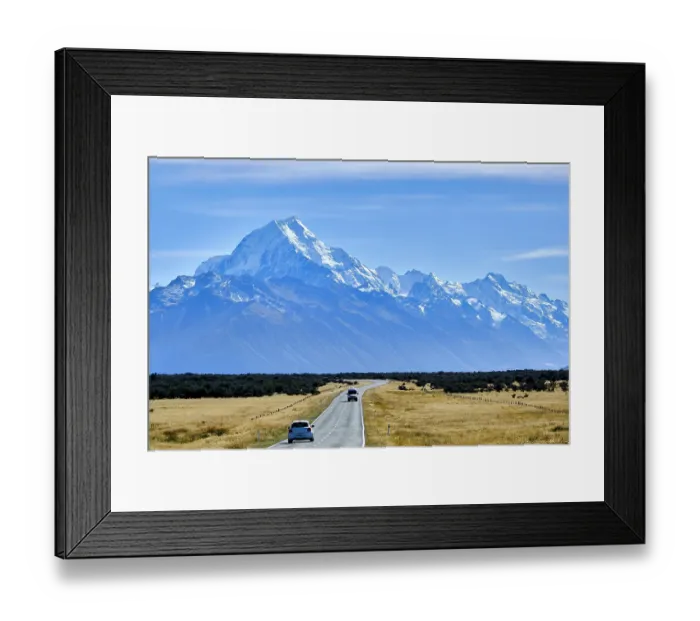 Framed Print : View of snow-capped Aoraki / Mount Cook (3724 m), with cars traveling along road in foreground, Mount Cook National Park, South Island, New Zealand. March, 2023 Framed Print : View of snow-capped Aoraki / Mount Cook (3724 m), with cars traveling along road in foreground, Mount Cook National Park, South Island, New Zealand. March, 2023
