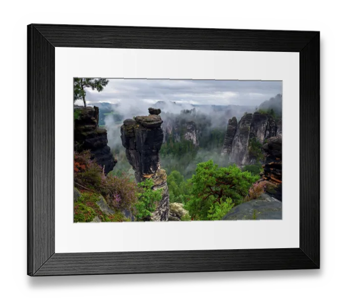 Framed Print : View over sandstone rock formations under low cloud with Scots pine (Pinus sylvestris) and Heather (Calluna vulgaris) on clifftops, Saxon Switzerland National Park, Saxony