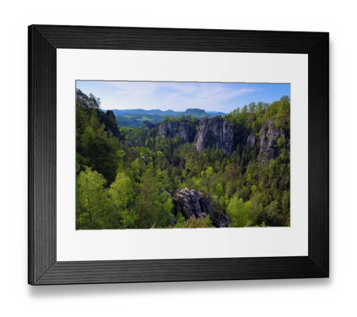 Framed Print : Sandstone rock formations and cliffs with mixed forest in valley. Table mountains in the background. Saxon Switzerland National Park, Saxony, Germany. May, 2021 Framed Print : Sandstone rock formations and cliffs with mixed forest in valley. Table mountains in the background. Saxon Switzerland National Park, Saxony, Germany. May, 2021