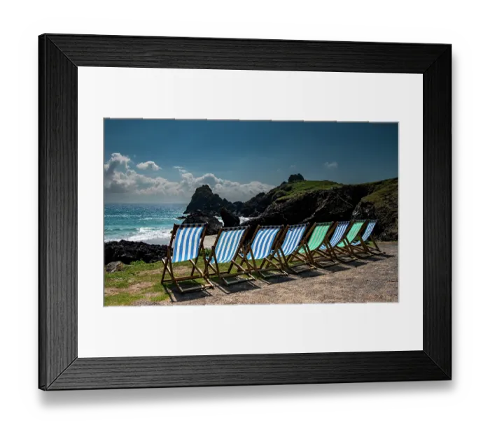Framed Print : Deck chairs overlooking the National Trust Kynance Cove on a sunny day, Lizard, Cornwall, England, UK. March, 2023
