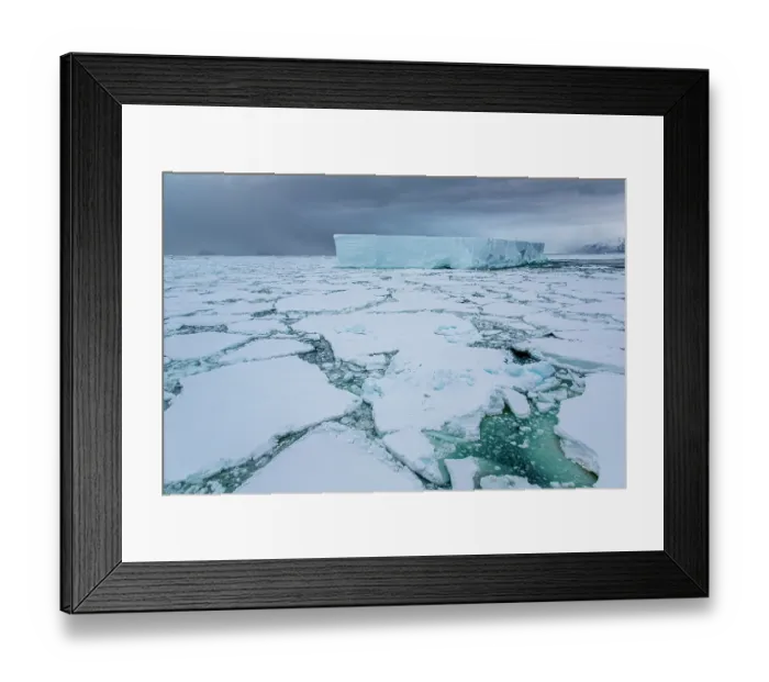 Framed Print : Iceberg amongst sea ice under dark sky, Coulman Island Area, Ross Sea, Antarctica. February, 2023 Framed Print : Iceberg amongst sea ice under dark sky, Coulman Island Area, Ross Sea, Antarctica. February, 2023