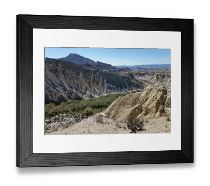 Framed Print : Dry river bed flanked by badlands of alluvial marl and clay deposits heavily eroded by seasonal water flow, Tabernas Desert, Almeria, Spain. March, 2024 Framed Print : Dry river bed flanked by badlands of alluvial marl and clay deposits heavily eroded by seasonal water flow, Tabernas Desert, Almeria, Spain. March, 2024